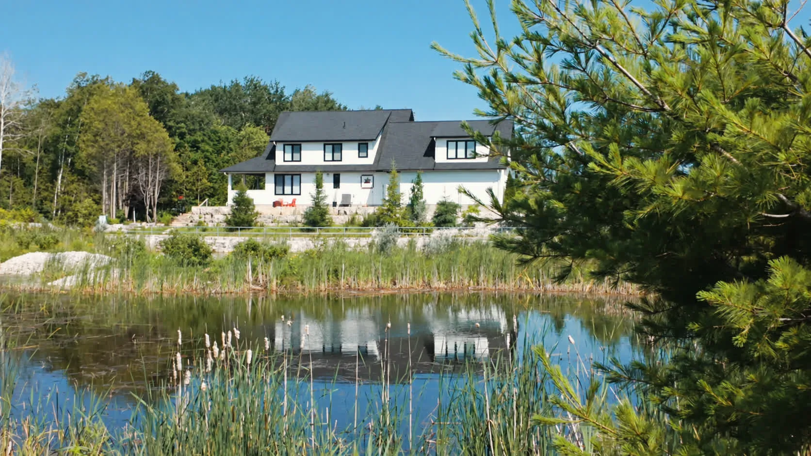 The naturalized pond, with a finished home reflected in it