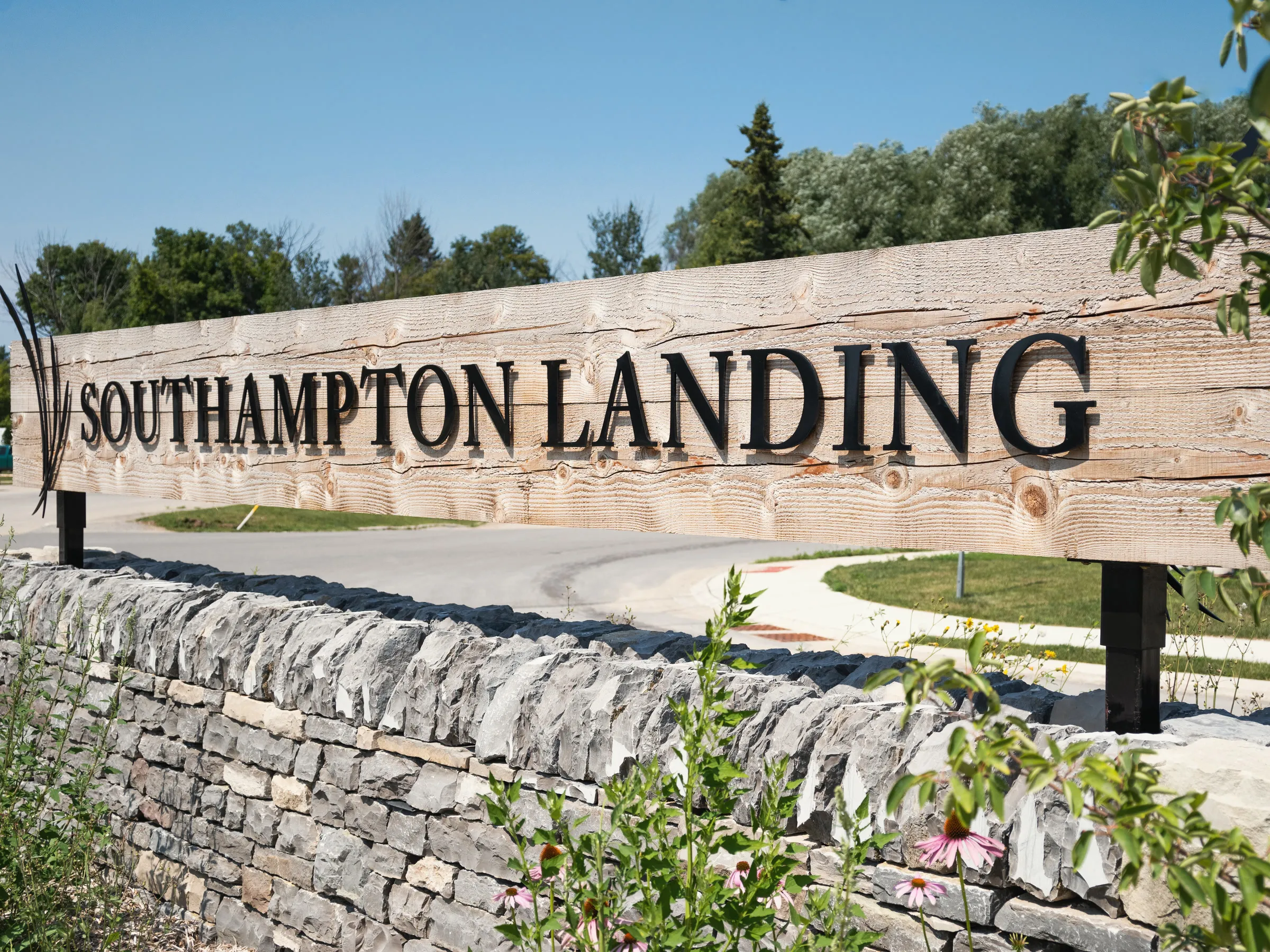 The Southampton Landing sign on its fieldstone wall at the neighbourhood's entrance